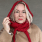 The Crown Hood Scarf by PoolaKnits is knitted in Drops Merino Extra Fine in colorway 11. The closest match in our selection is Sandnes Garn Alpakka Ull in color 4227 Equestrian Red.