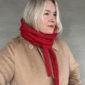 The Crown Hood Scarf by PoolaKnits is knitted in Drops Merino Extra Fine in colorway 11. The closest match in our selection is Sandnes Garn Alpakka Ull in color 4227 Equestrian Red.