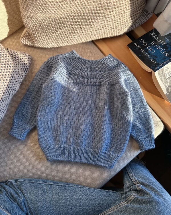 PetiteKnit Anker’s Sweater is knitted in Peer Gynt in the color Blue Heather 6324 from Sandnes Garn. PetiteKnit Anker’s Sweater is knitted in Peer Gynt in the color Blue Heather 6324 from Sandnes Garn.