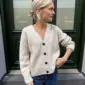 The white Champagne Cardigan is knitted in Double Sunday by Sandnes Garn in the color Almond [2511] held together with Tynn Silk Mohair by Sandnes Garn in the color Kitt [1015].