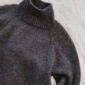 The charcoal grey Louvre Sweater is knitted in Peer Gynt by Sandnes Garn in the color Charcoal Grey Heather [1088].