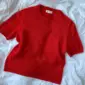 The red Poppy Tee is knitted in Cashmere Classic by Cardiff in the color Hermes [517].