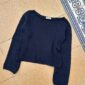 The blue Sevilla Blouse is knitted in Palet by Isager in color Navy held together with Trio 1 by Isager in the color Navy.