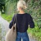 The black Sevilla Blouse is knitted in Line by Sandnes Garn in color Black [1099] held together with Tynn Line by Sandnes Garn in color Black [1099].