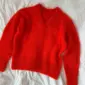 The red Stockholm Sweater V-Neck is knitted in Tynn Silk Mohair by Sandnes Garn in the color 4008 Poppy. The color is discontinued and the closest match in our selection is the color 4018 Scarlet Red.